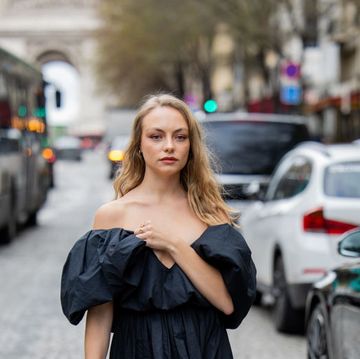 paris, france march 01 anouchka gauthier wears black off shoulder dress, red bag outside nina ricci during the womenswear fallwinter 20242025 as part of paris fashion week on march 01, 2024 in paris, france photo by christian vieriggetty images