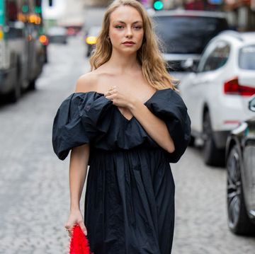 paris, france march 01 anouchka gauthier wears black off shoulder dress, red bag outside nina ricci during the womenswear fallwinter 20242025 as part of paris fashion week on march 01, 2024 in paris, france photo by christian vieriggetty images