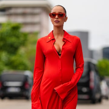 Street Style - Day 2 - Milan Fashion Week - Womenswear Spring/Summer 2025 milan, italy september 18 a guest wears dark red sunglasses, silver earrings, bright red long sleeve buttoned maxi dress, light green leather bag, black open toe heels, outside jil sander, during the milan fashion week springsummer 2024 2025 on september 18, 2024 in milan, italy photo by edward berthelotgetty images