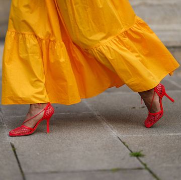 paris, france june 05 emilie joseph infashionwetrust wears a yellow asymmetric cut out midi dress from mango, red mesh toe cap strappy pumps heels shoes from bottega veneta, a gold ring, on june 05, 2021 in paris, france photo by edward berthelotgetty images
