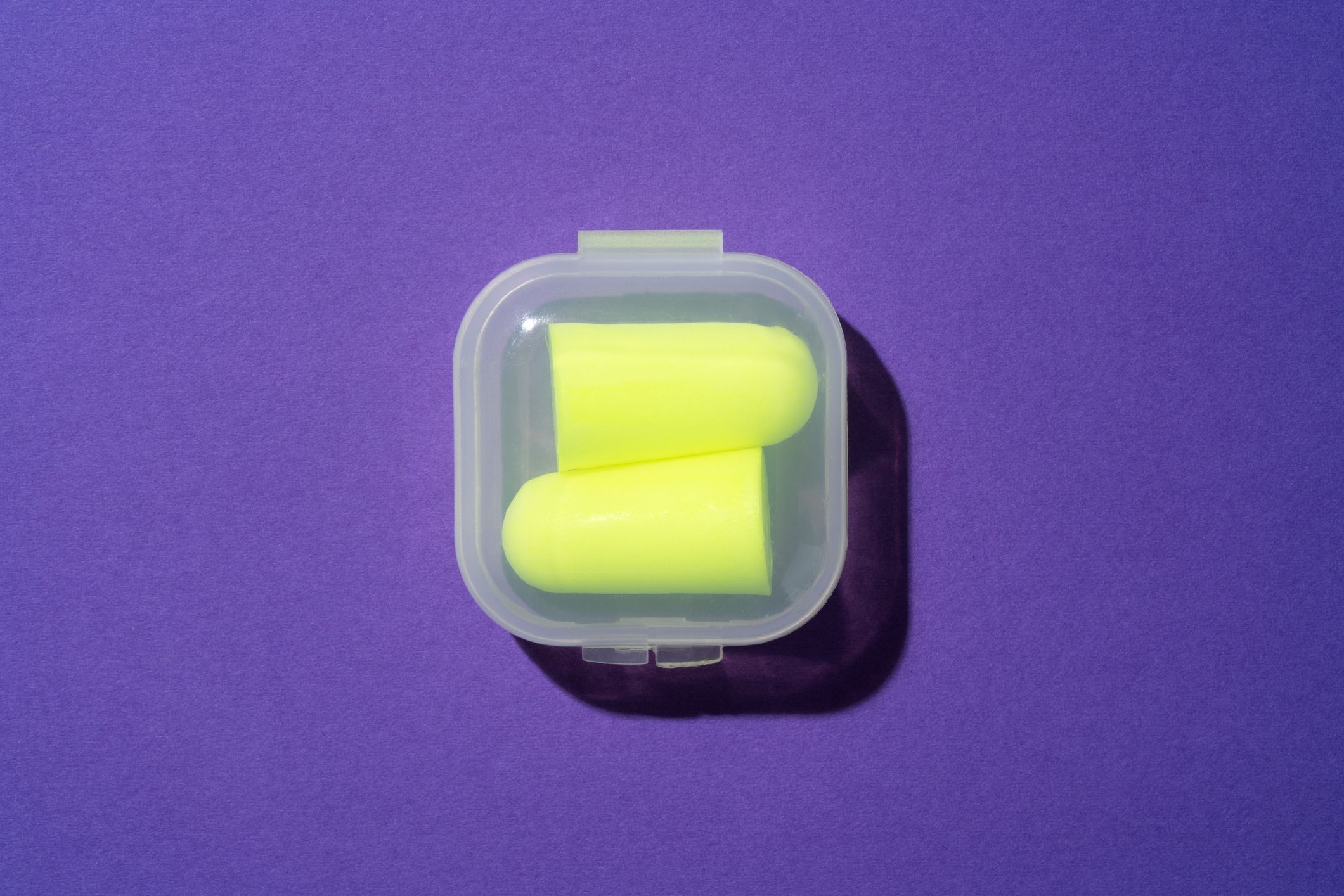 vibrant yellow ear plugs in plastic box