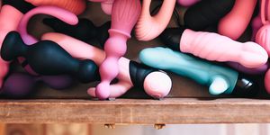 drawer full of vibrators and sex toys