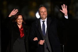 kamala harris and doug emhoff locking arms and waving