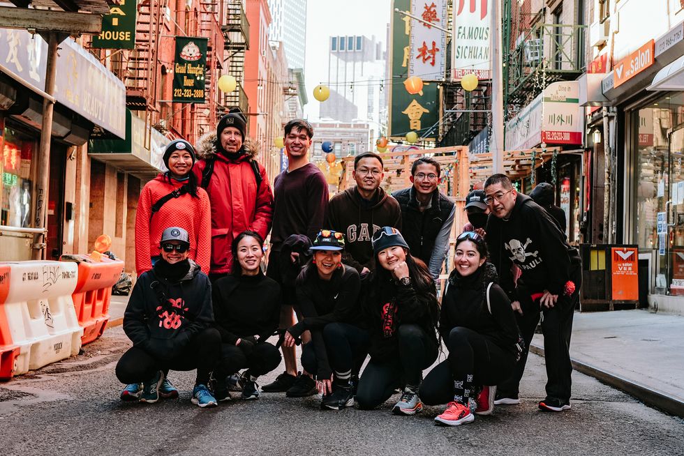 chinatown runners posing for a photo on a street