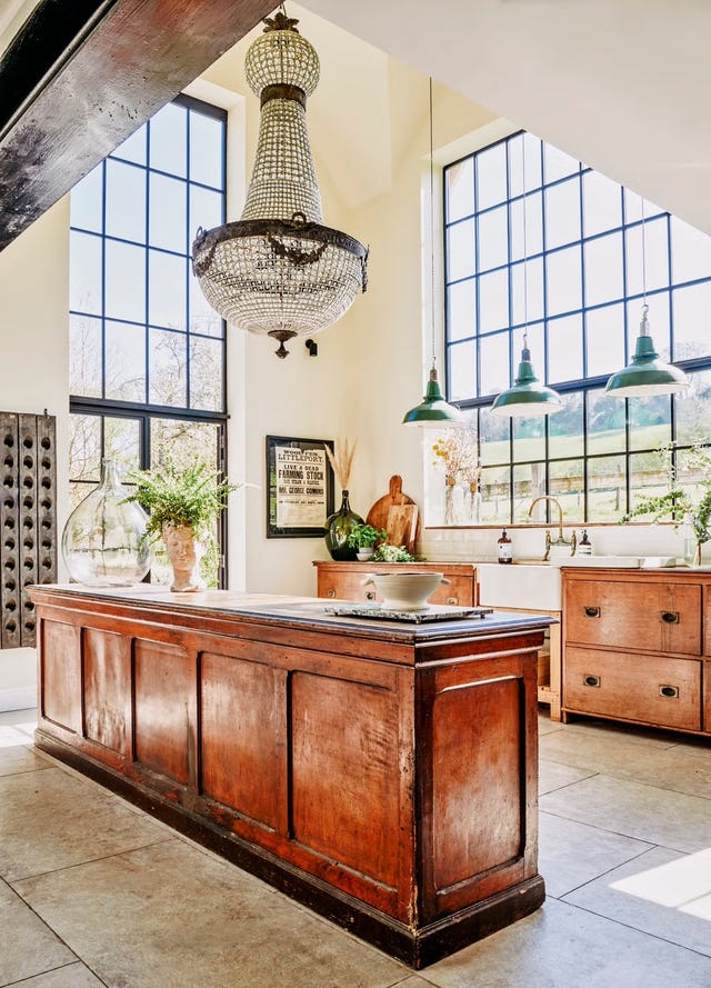 the kitchen showcases a large wooden island with a polished top, complemented by a decorative bowl at its center