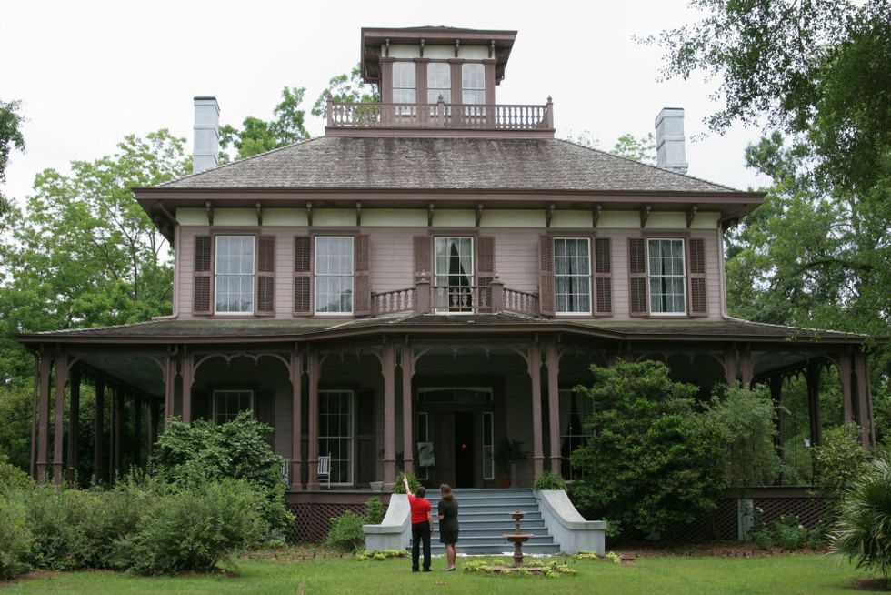 a couple looking at a italianate style mansion fendall hall