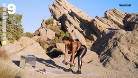 individual performing a workout outdoors with dumbbells