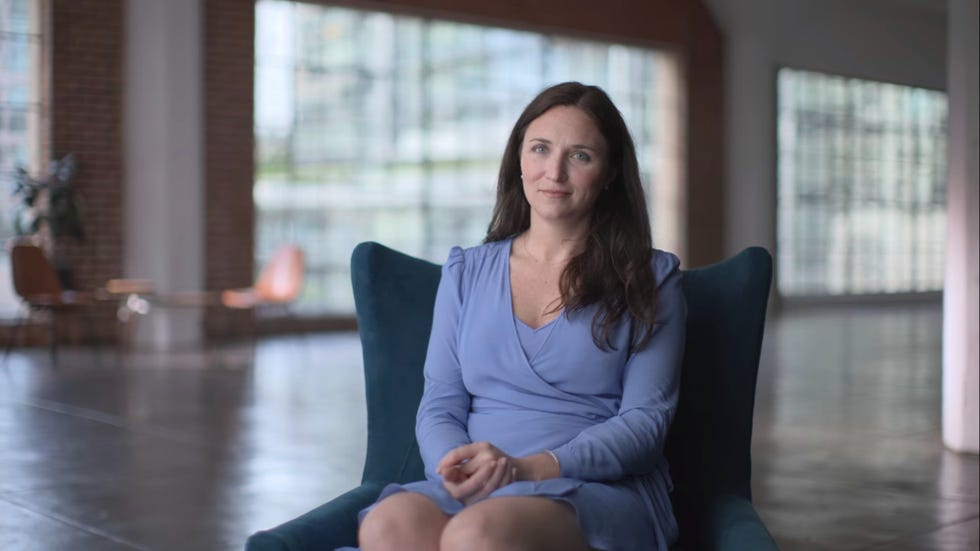 ashleigh sits in chair wearing blue dress