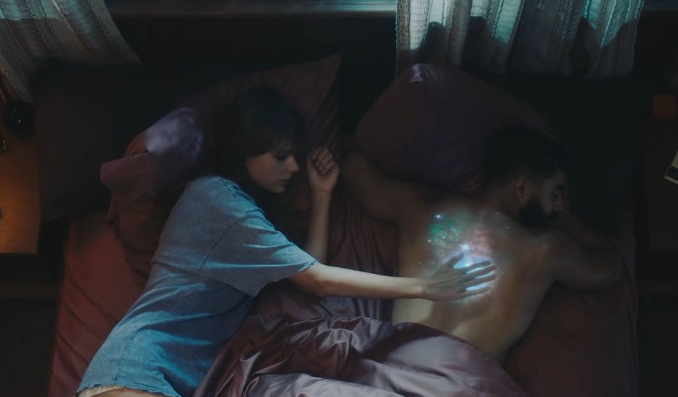 taylor swift and laith ashley lying in bed in the lavender haze music video