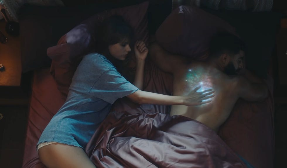 taylor swift and laith ashley lying in bed in the lavender haze music video