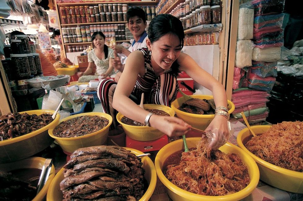 Verse etenswaren worden aan de man gebracht op de makrt van Chau Doc