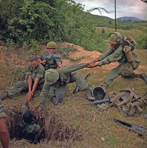 american soldiers uncovering a vietcong tunnel, 1968