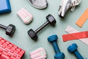 view from above dumbbells and exercise equipment   knolling