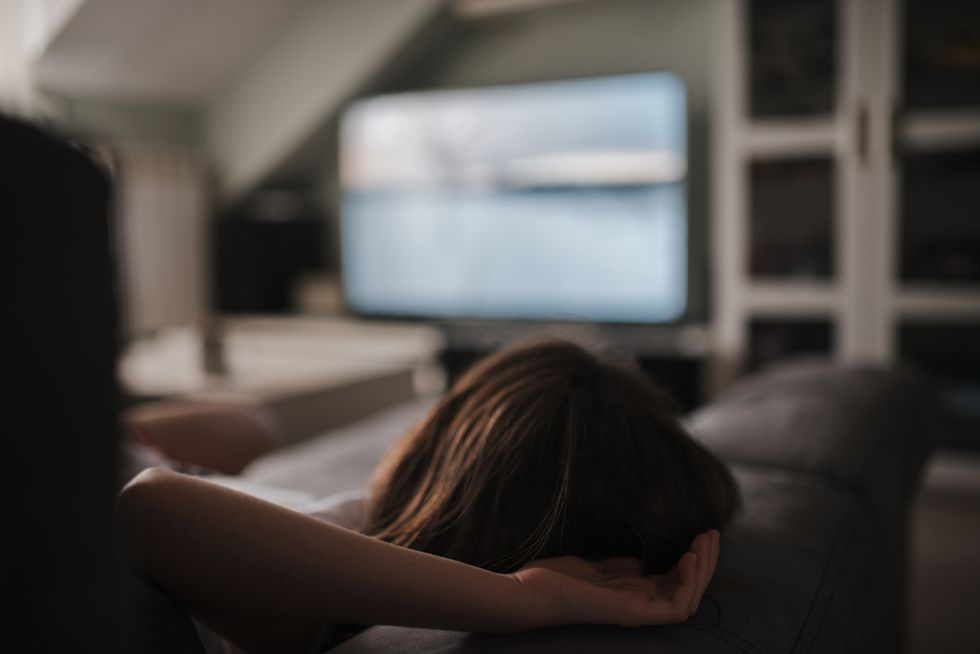 woman relaxing watching a film on tv
