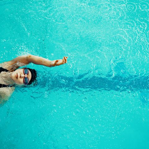 view from directly above a paraplegic woman training in a pool for competitive swimming