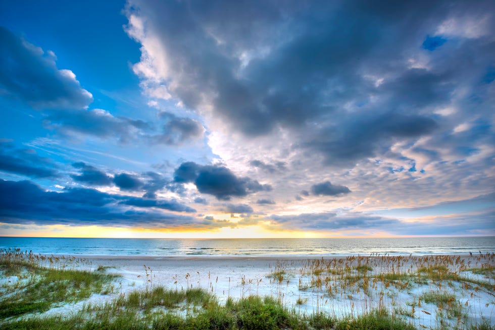 View of Beach against a blue sky with clouds