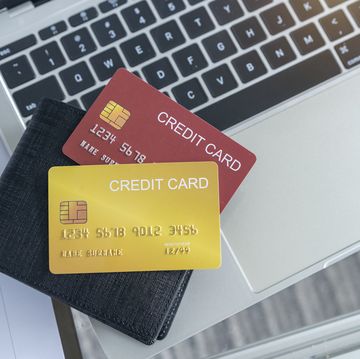 view of desk with credit card in the wallet on computer laptop