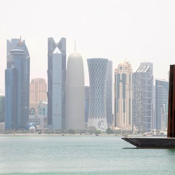 view of doha skyline with richard serra scuplture, doha, qatar