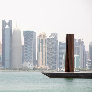 view of doha skyline with richard serra scuplture, doha, qatar