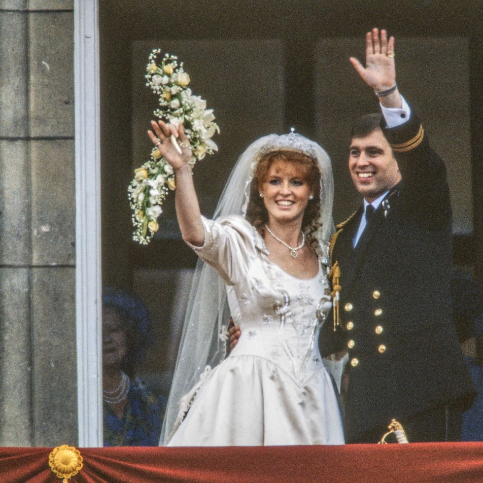view of just married couple sarah, duchess of york, and prince andrew, duke of york, as they wave from the balcony of buckingham palace, london, england, july 23, 1986. (photo by derek hudson/getty images)