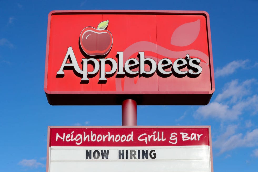 a view of "now hiring" sign and logo at an applebee's