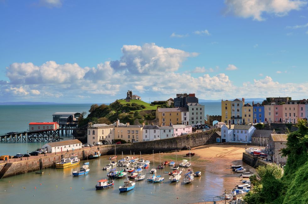 view of tenby harbour with castle hill