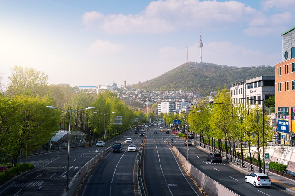 view of the n seoul tower and city traffic at dusk in seoul, south korea
