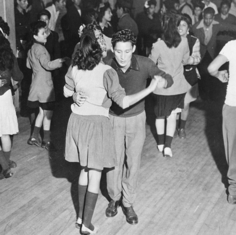 view of young men and women as they dance the jitterbug at the club los pachucos, los angeles, california, november 13, 1943 as part of an effort to combat juvenile delinquency, civic leaders had converted a deserted night club into the recreation center for use by the youths