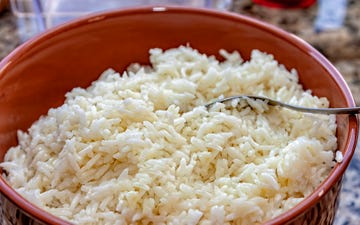 viewed from above bowl with cooked white rice, a very popular side dish for brazilian feijoada