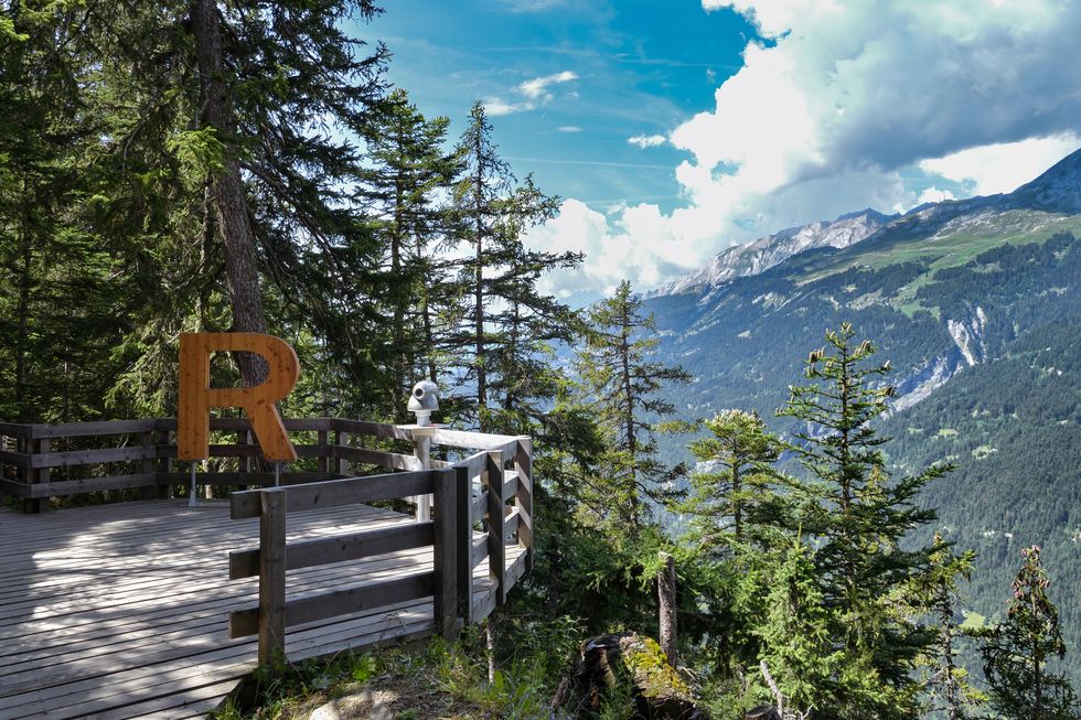 viewing platform with big letter r at the beginning of bisse du ro walking trail close to crans montana