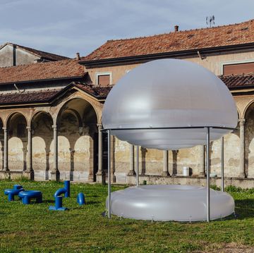 a large white dome with blue buckets in front of it