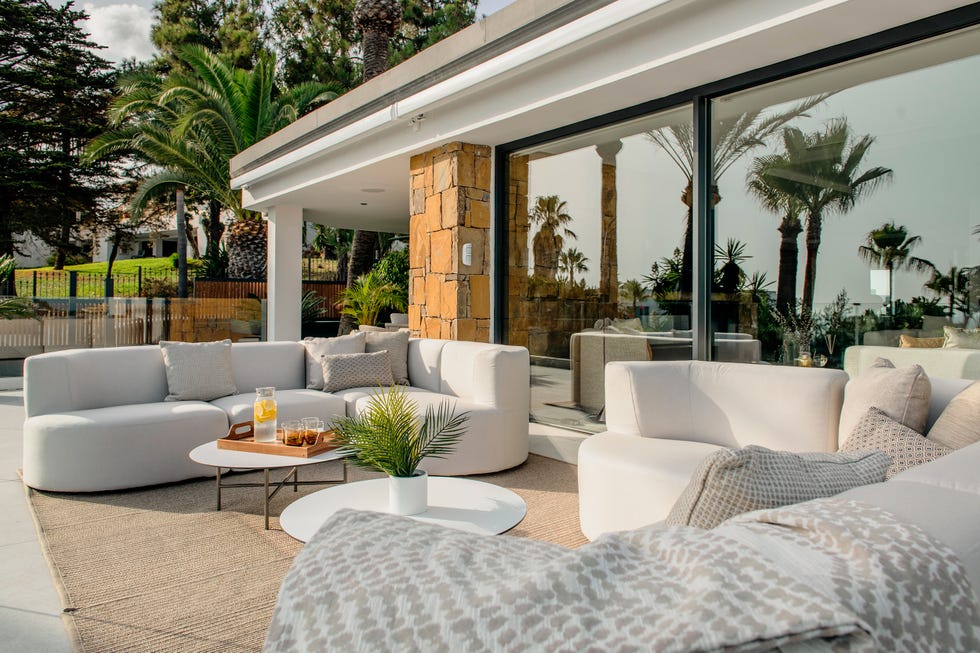 terraza con sofás curvos y mesas de centro redondas