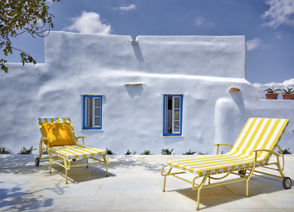 Yellow, Outdoor furniture, Door, Sunlight, Shade, Sunlounger, Street furniture, Cottage, Armrest, Snow, 