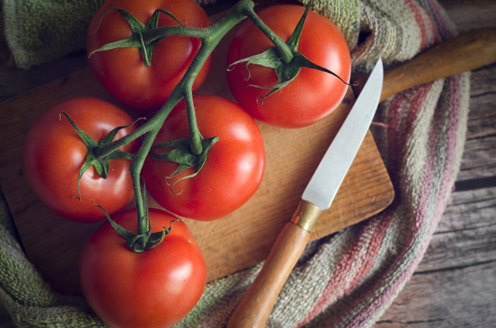 vine tomatoes on a cutting board, top view