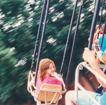 vintage 1990s child having fun at amusement park family photo