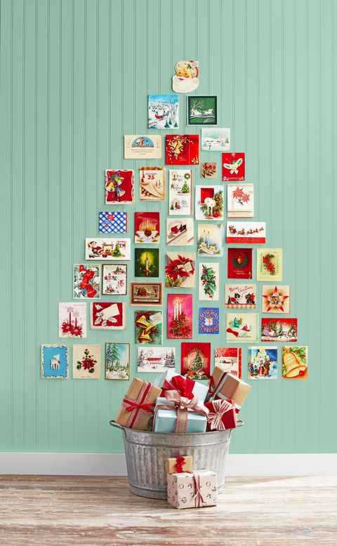 vintage holiday cards arrnaged on the wall in the shape of a christmas tree