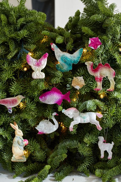 colorful ornaments on a christmas tree in the shape of animals like roosters and swans and birds and bunnies