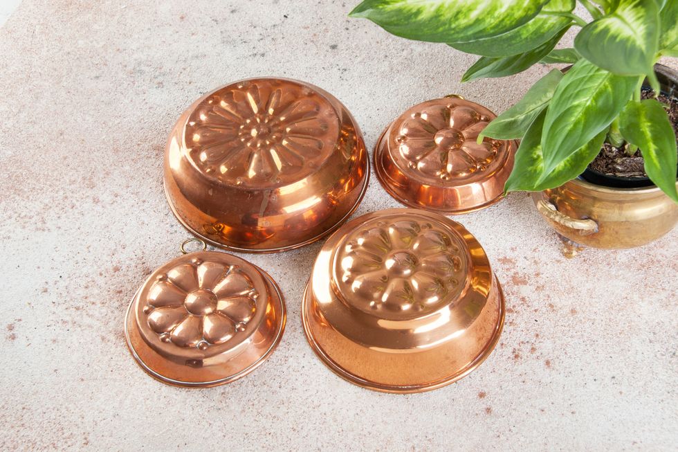 vintage copper molds on a concrete background.