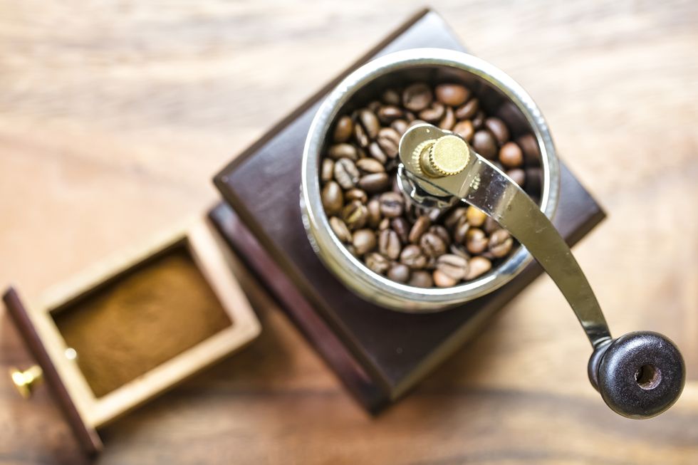 vintage manual coffee grinder and coffee beans