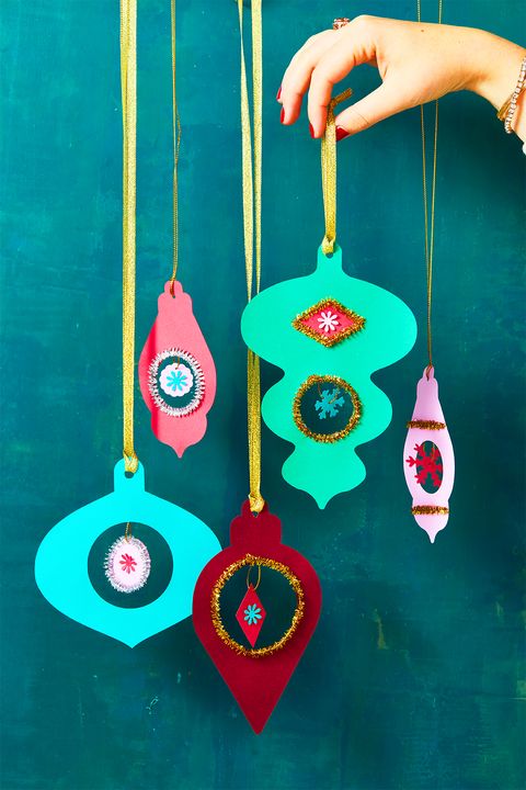 vintage style paper diy christmas ornaments hanging from yellow ribbon