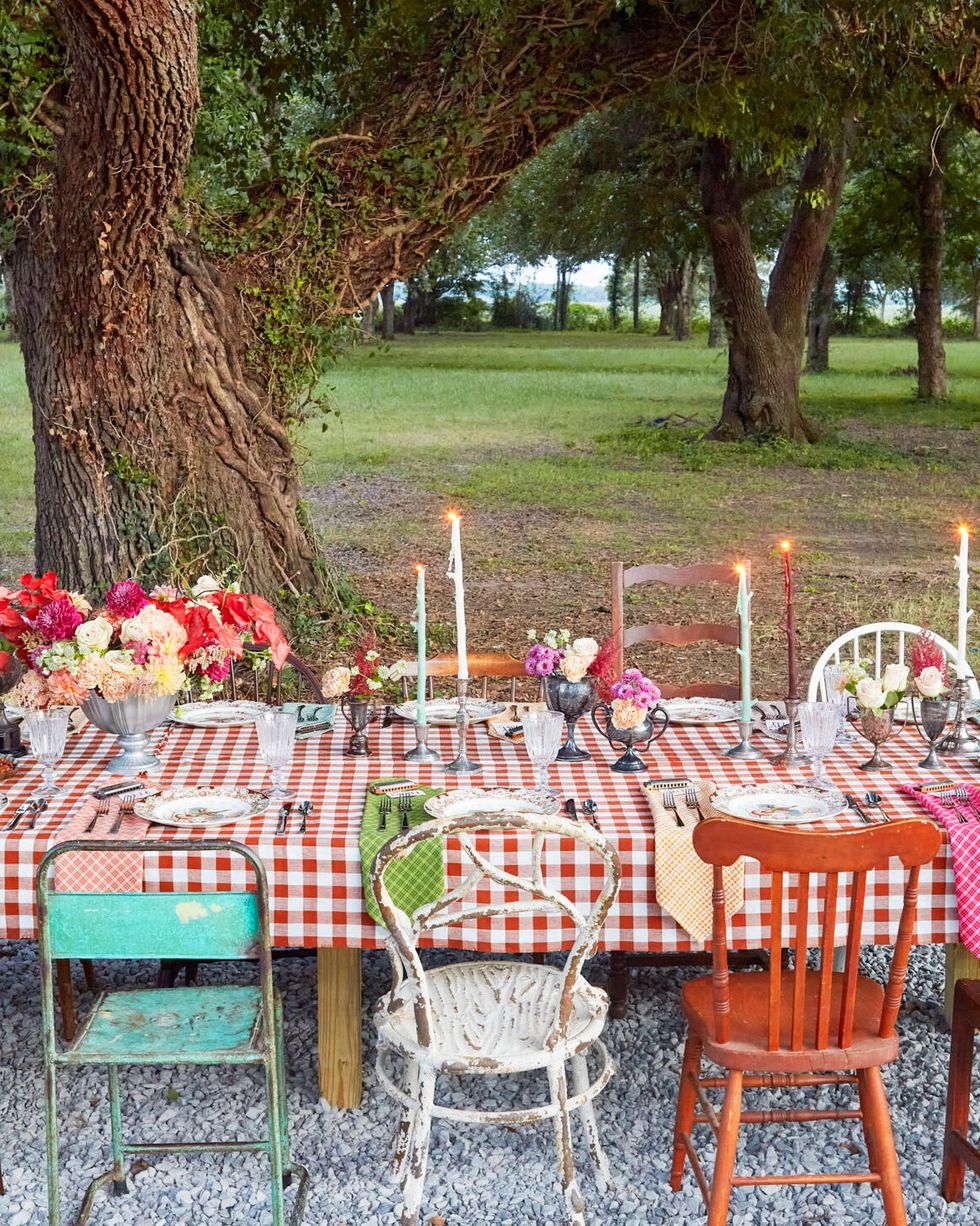 outdoor farm table with fall arrangements in vintage trophies