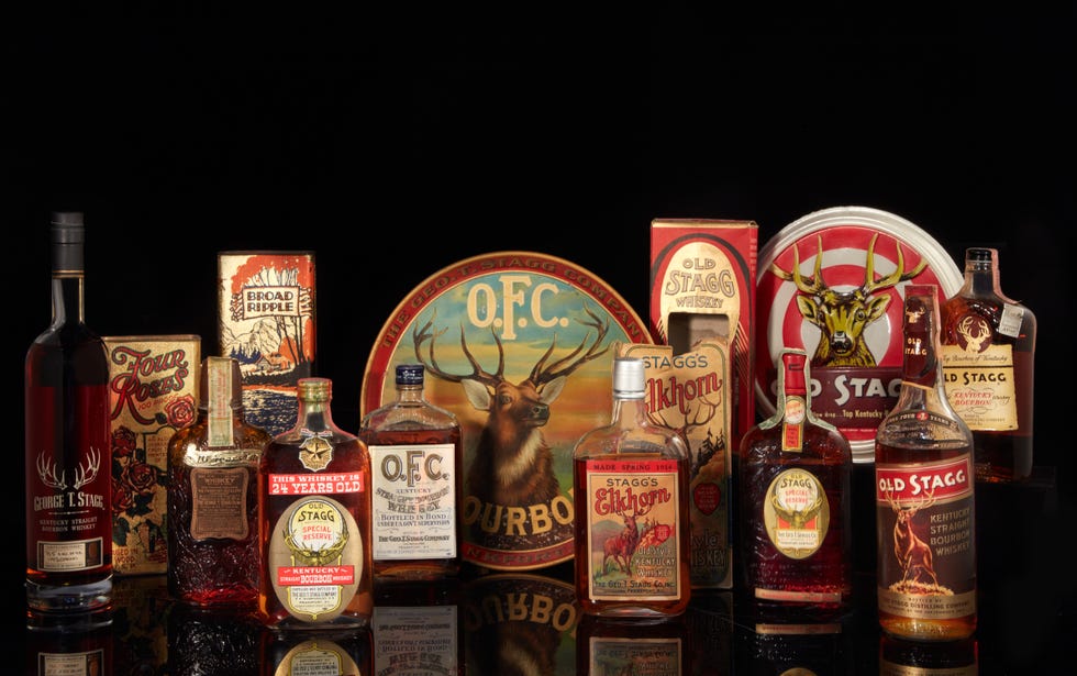 vintage whiskey bottles on a black tabletop.
