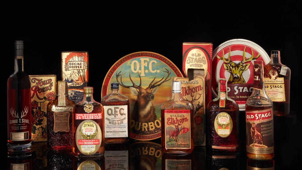 vintage whiskey bottles on a black tabletop.