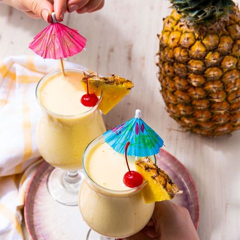 virgin pina coladas topped with marachinos, pineapple wedges, and cocktail umbrellas