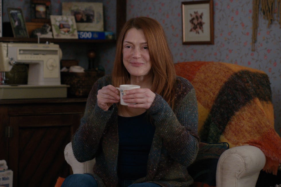 lynda boyd as lilly in virgin river, sitting in armchair holding a cup