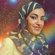 a woman wearing a patterned hijab is seen in a starry rainbow sky