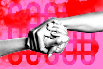 hands holding on a pink and red background