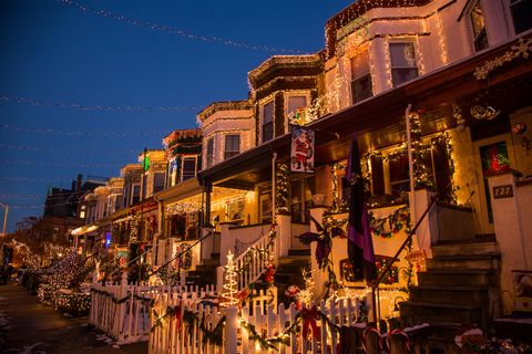 row houses decorated for christmas with bright lights and christmas greenery