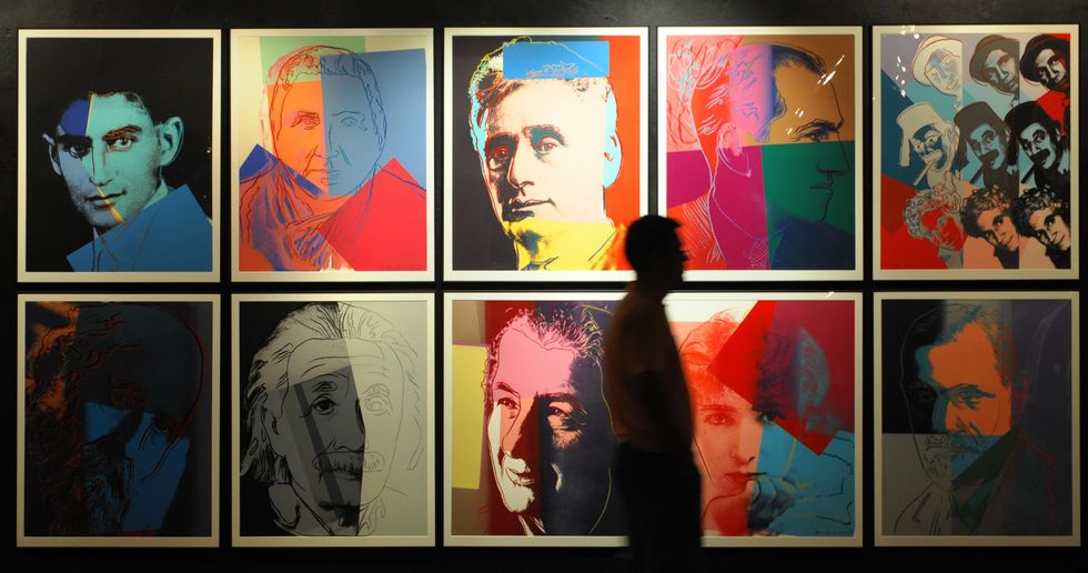 a visitor passes by andy warhol's screen