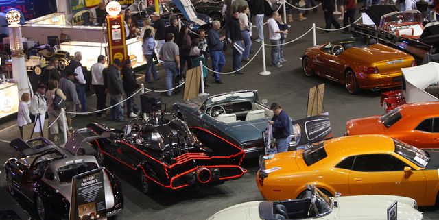 Visitors look at vintage automobiles dur